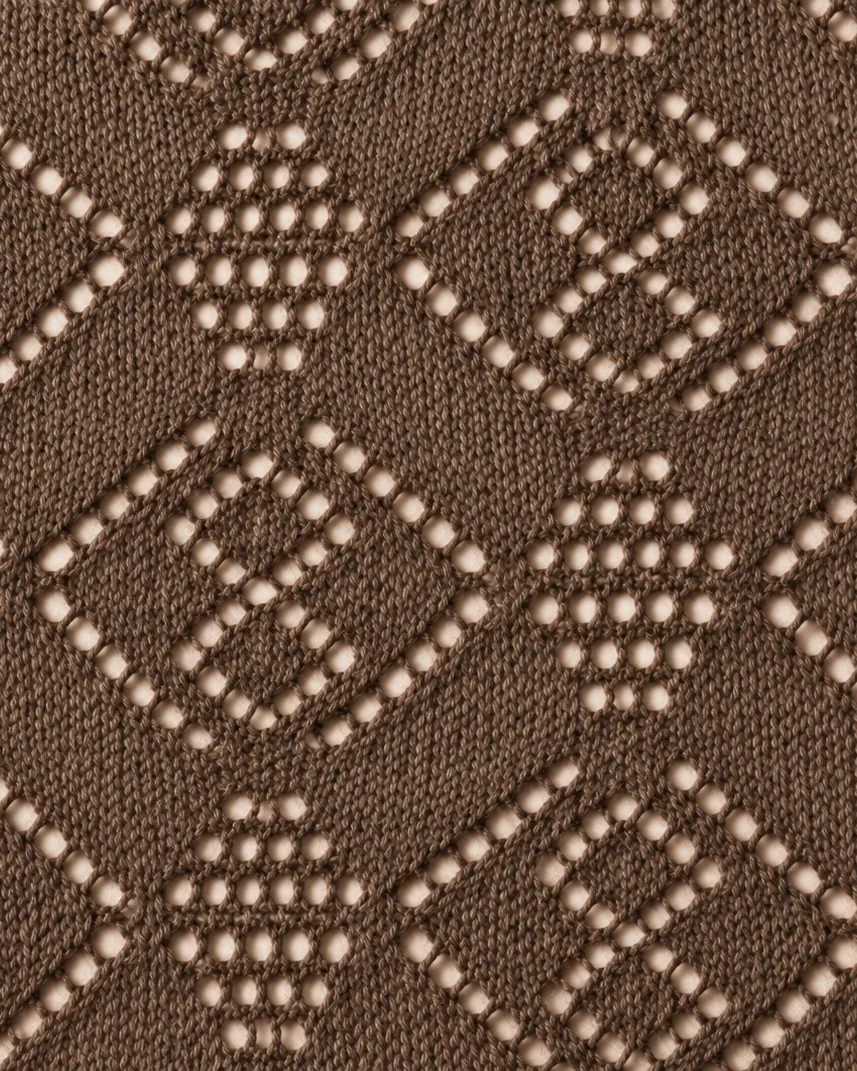 Close detail of an open lace stitch in qiviut.